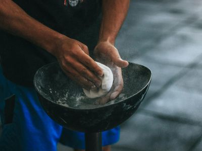 Chalked hands of an athlete before a heavy lift