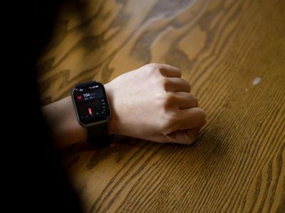 Fitness tracker on a wrist showing heart rate data