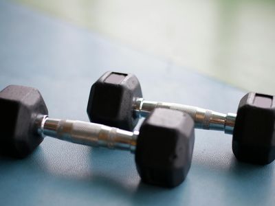 Pair of heavy dumbbells on a black rubber floor